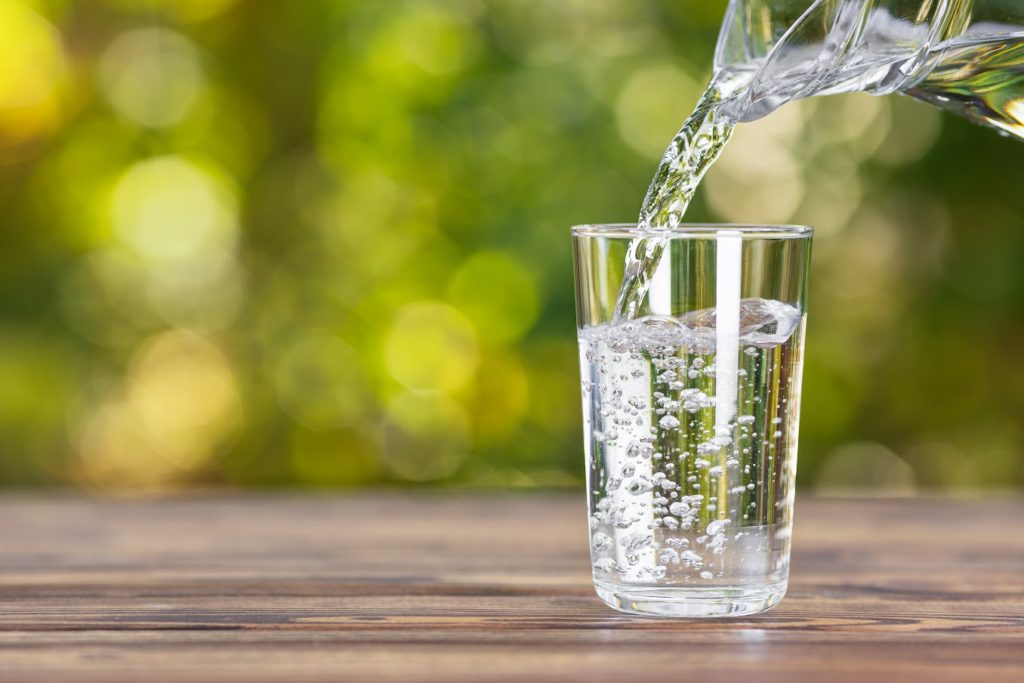 Water being poured into a clear glass.