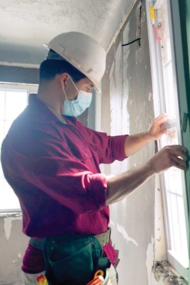 A worker performing lead abatement inside a home