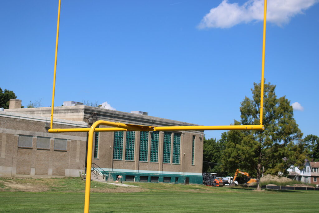 Goal post of Haskell football field with building in the background
