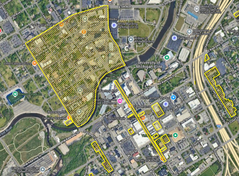 A screenshot of the Flint Parcel Hub. Satellite overhead view of downtown and Carriage Town. Local historic districts and properties are highlighted with bright yellow diagonal lines overlaid onto the satellite image.