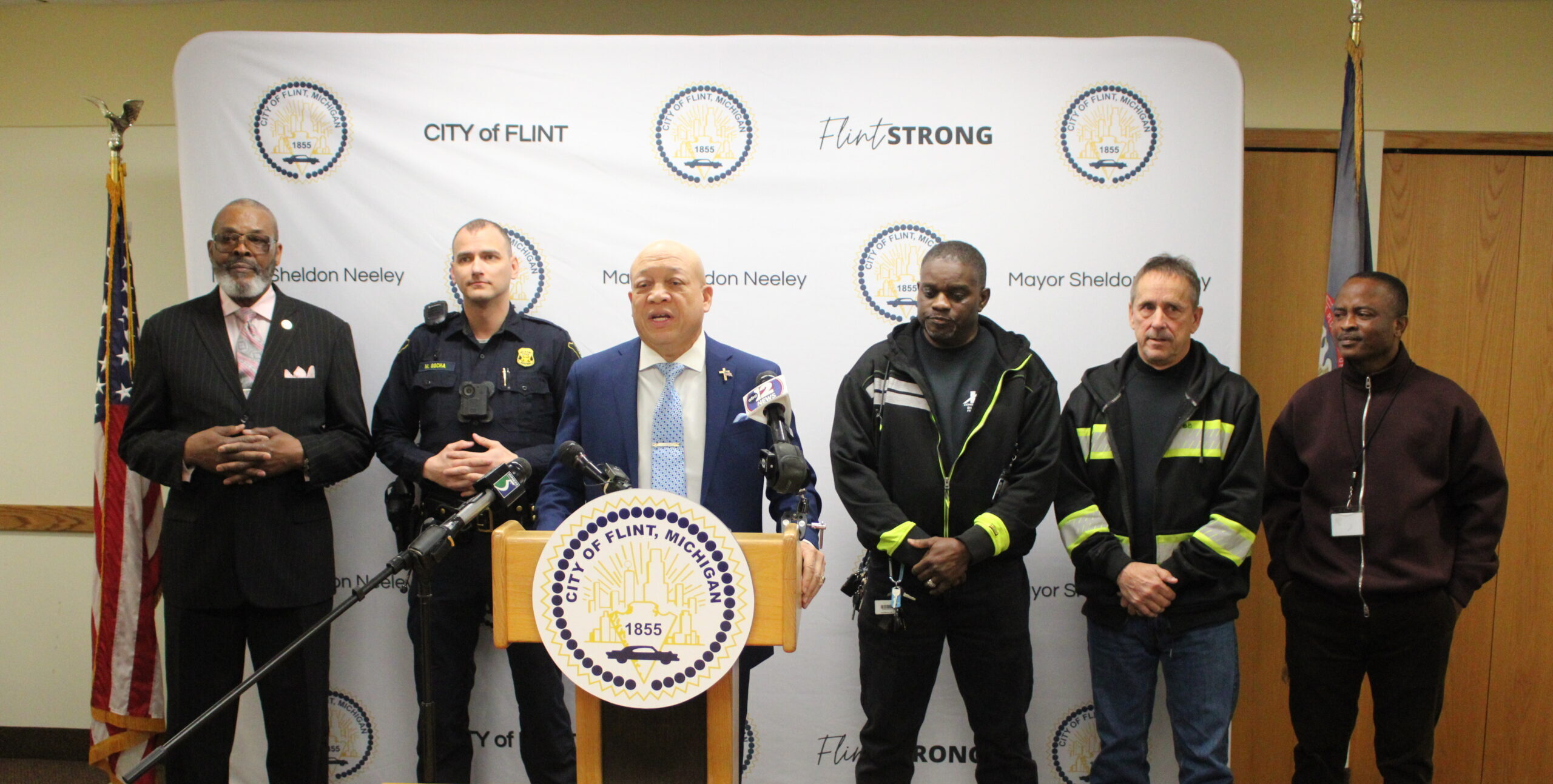 City officials line up behind Mayor Sheldon Neeley during a press conference.