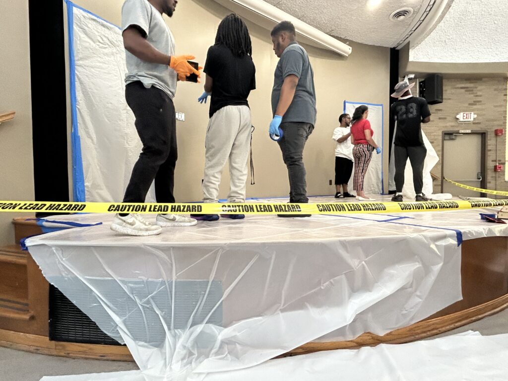 Picture of safety tape and plastic sheeting on the stage floor in the Dome of City Hall as lead abatement training takes place.