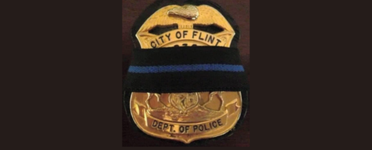 Mayor Neeley lowers city flag in honor of Flint Police Captain